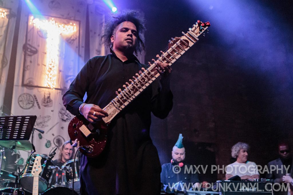 Aji Jafri of The Shadow Majlis Onstage with a sitar