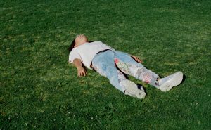 photo of taewook lucas kang of 3kelves laying on grass